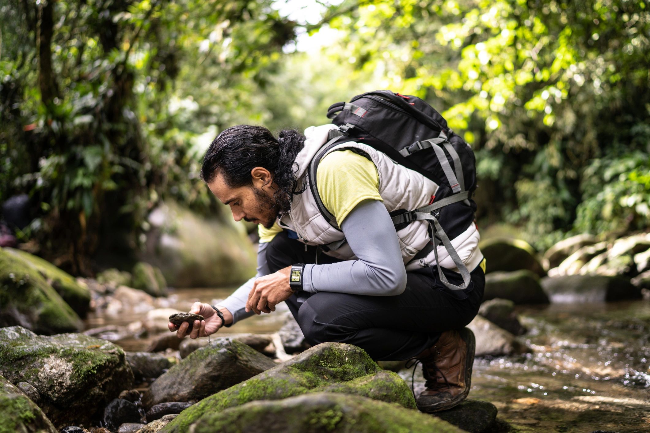Field professional examining a rock sample