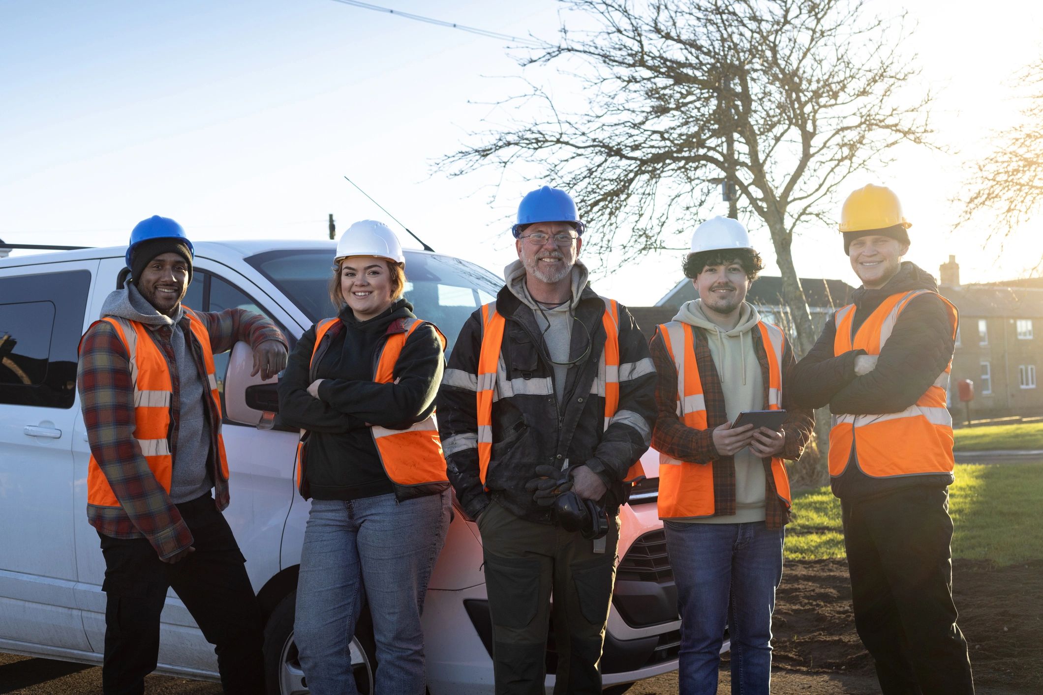 Field team in safety gear standing together at a worksite